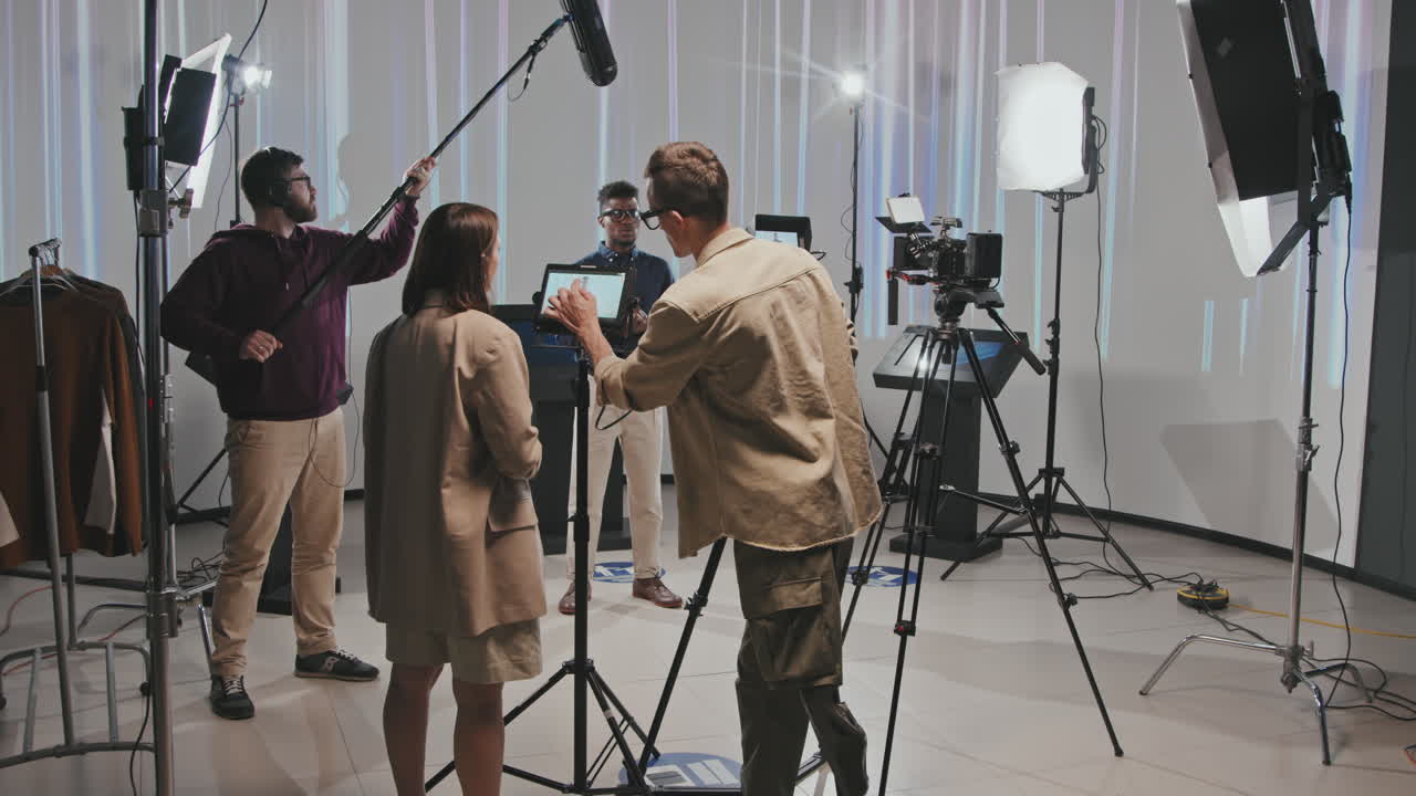 Cameraman With Leg Prosthesis Working With Crew In Studio