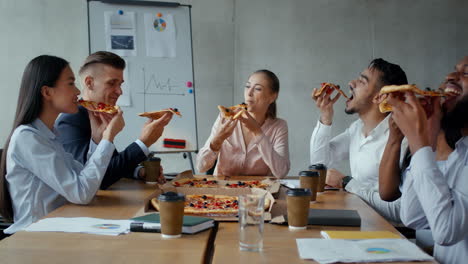 business team eating pizza during meeting