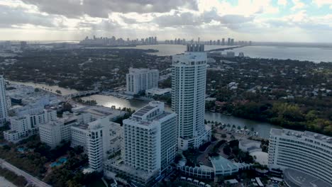 aerial view of luxury hotel buildings lining the shore of mid-beach area in miami beach, florida