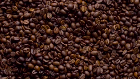 4k footage. 4096x2304p.fragrant coffee beans are roasted in a frying pan, smoke comes from coffee beans. the whole composition scrolls slowly around the camera. scoop stir coffee beans.