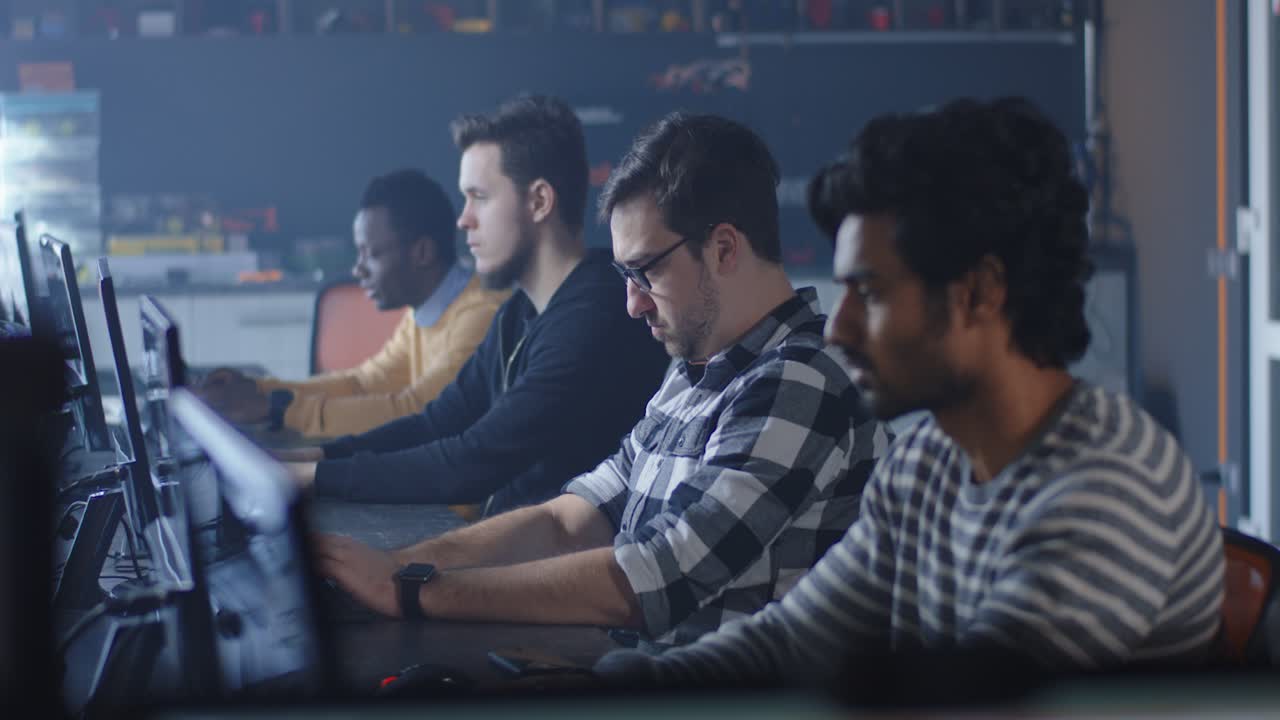 Team of programmers working at a computer in an office