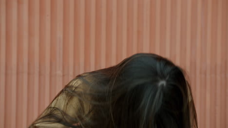 woman smiling at the corrugated metal wall