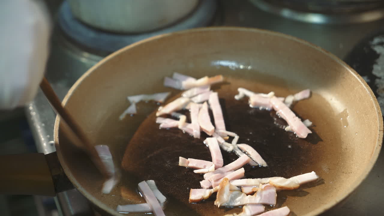 Frying bacon in a frying pan