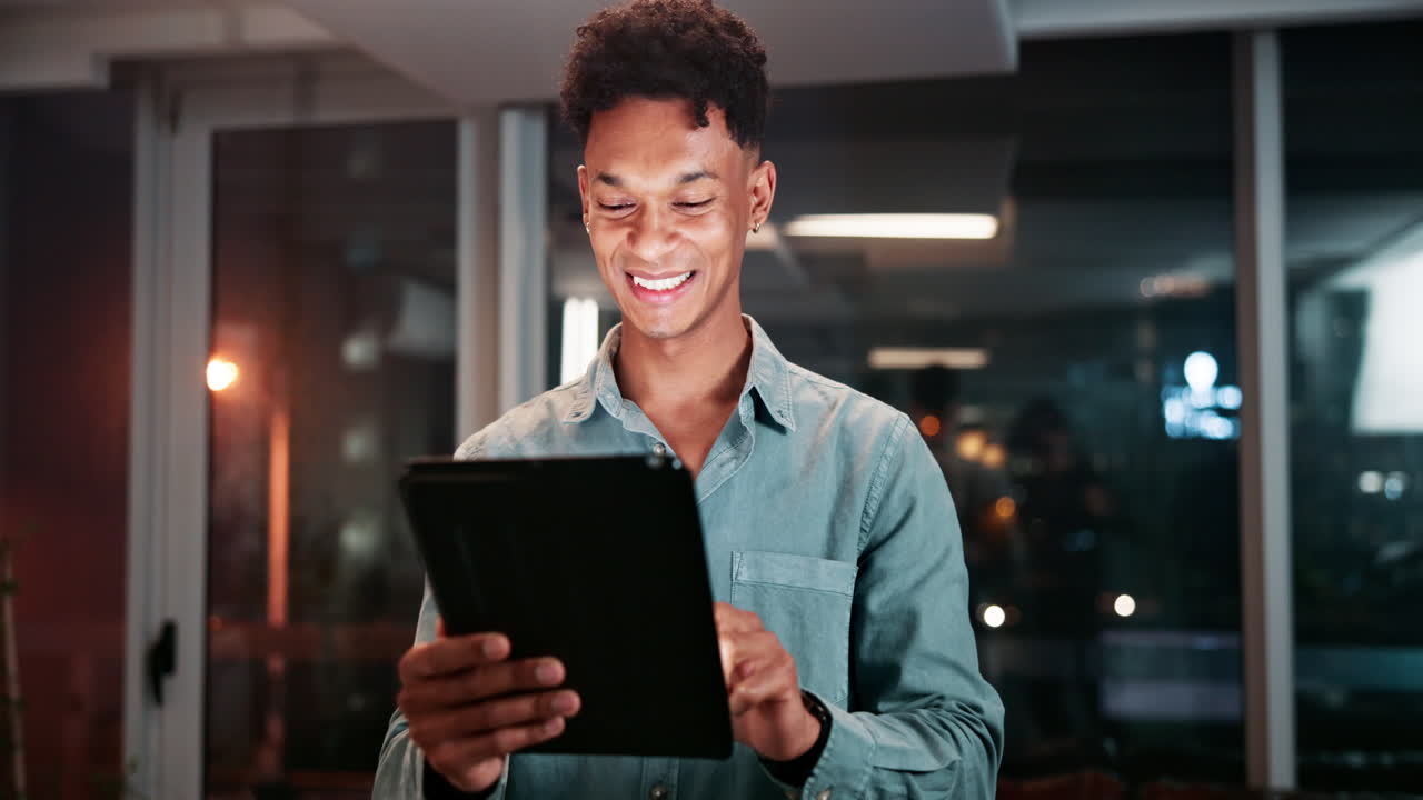 Young Professional Using Tablet at Night