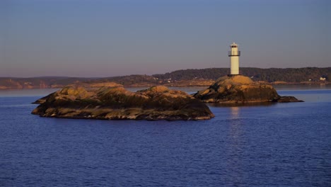 lighthouse strömstad stromstad fjord ursholmen sweden sea ferry boat ride land of the svea sverige calm sea ocean water arctic afternoon sunset nordkoster enchanting coastal reflection circle motion