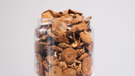 closeup of a jar of dried mushrooms spinning in a circle dry mushrooms closeup of a jar of dried mushrooms spinning in a circle dry mushrooms