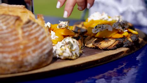 Putting-white-cheese-on-bread-on-outside-surface