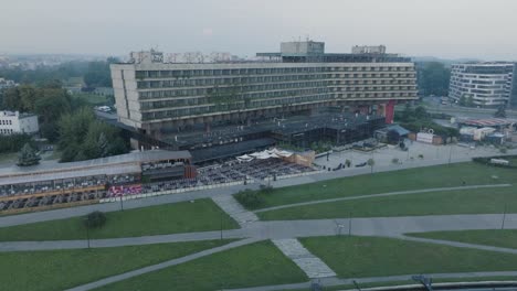 Aerial-Drone-Shot-Krakow-Poland-Abandoned-Soviet-Brutalist-Structure-Hala-Forum-at-Sunrise