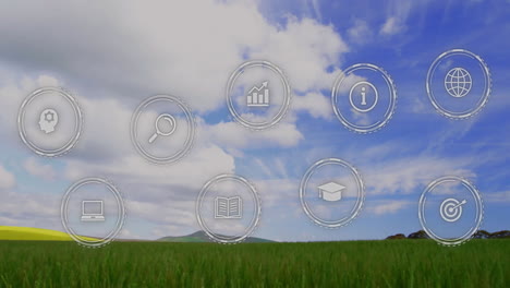 animation of icons overlaying grassy landscape with blue sky in background