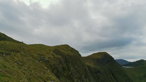 Aerial-over-the-rugged-hills-under-overcast-skies-near-Vanylven-Municipality,-Norway