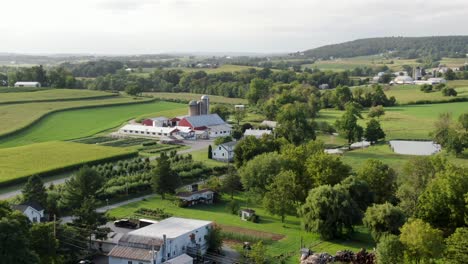 aerial reveal shot of american farm in rural lancaster county pennsylvania, usa, summer shot