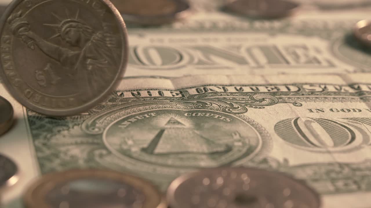 1 US coin spining on Dollar Bank.