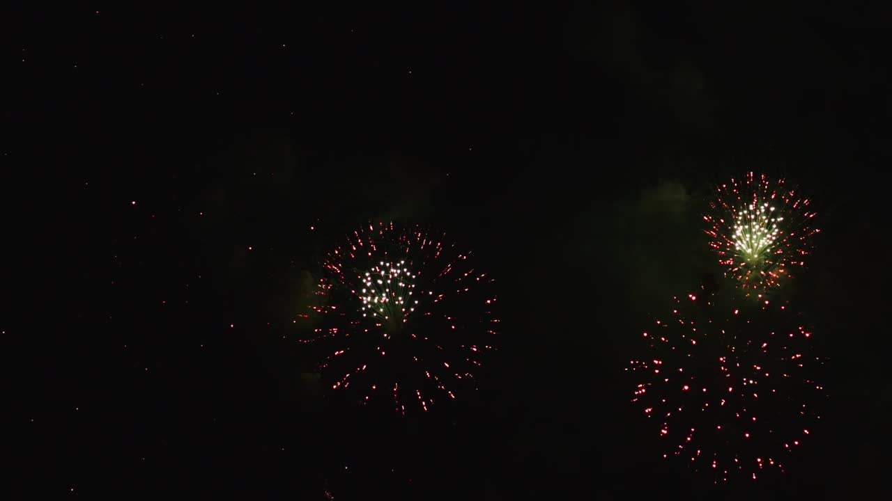 Real fireworks exploding celebration frame fill and loop seamlessly abstract blur bokeh lights in the night sky with the glowing fireworks show festival