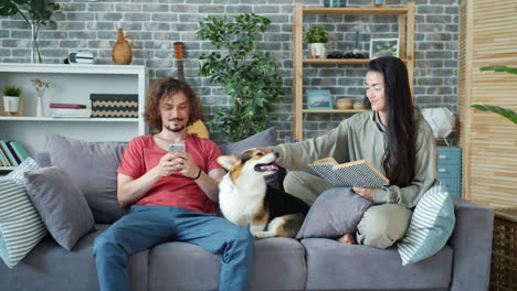couple relaxing at home with dog