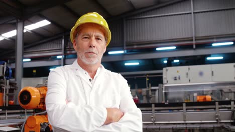 worker standing with arms crossed in factory