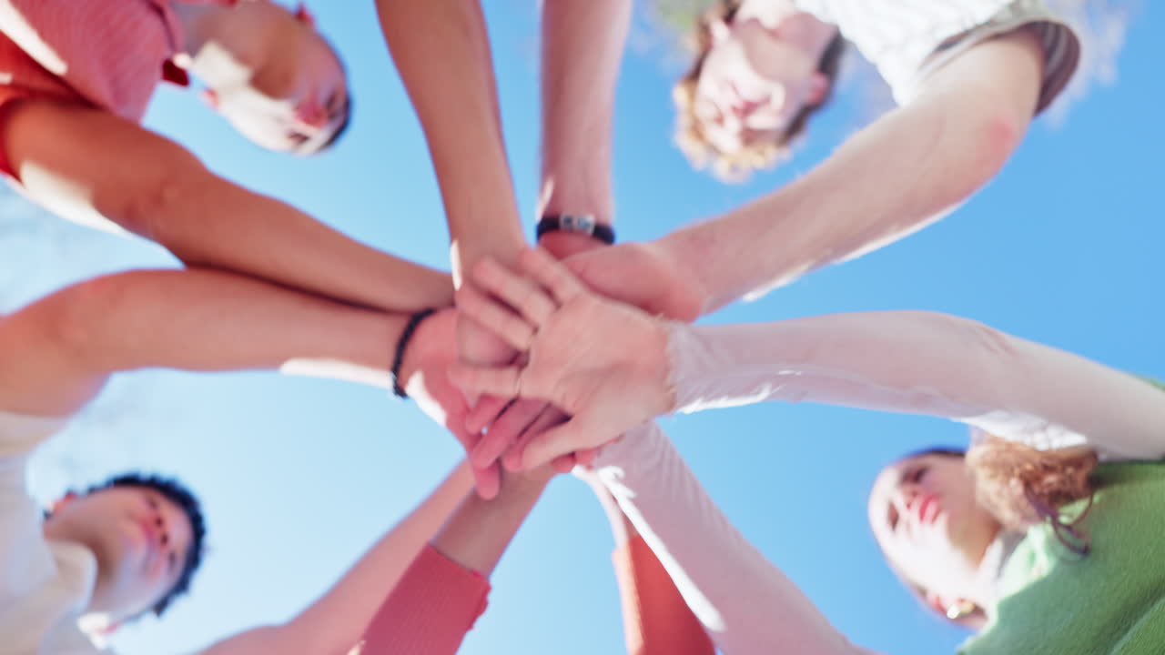Group of people joining hands in unity