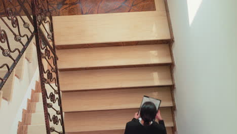 top view of company manager walking up the stairs