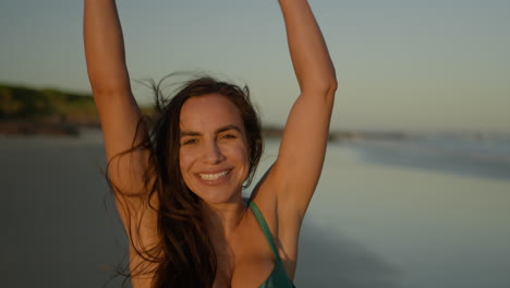 young woman jumping on the sand