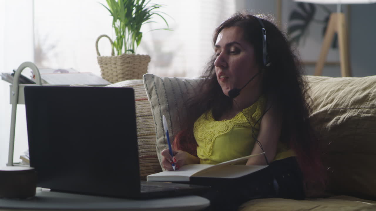 Vertical Portrait of Smiling Woman with Disability Working on Laptop at Home