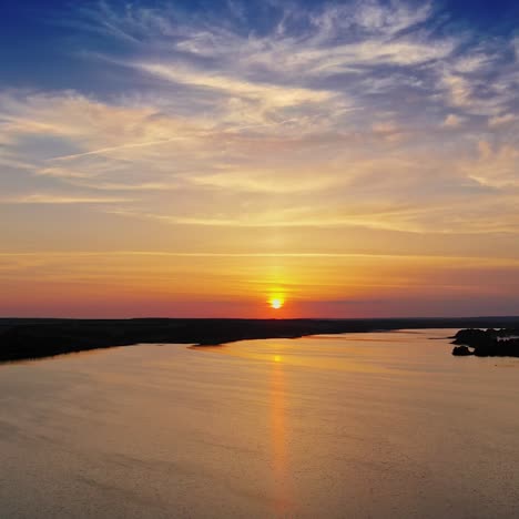 golden path over the river at sunset. beautiful view on the natural landscape with evening sun that reflects in water. camera moves down.