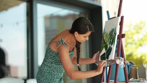 woman painting a landscape outdoors