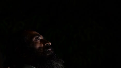 young man in the dark looking hopeless