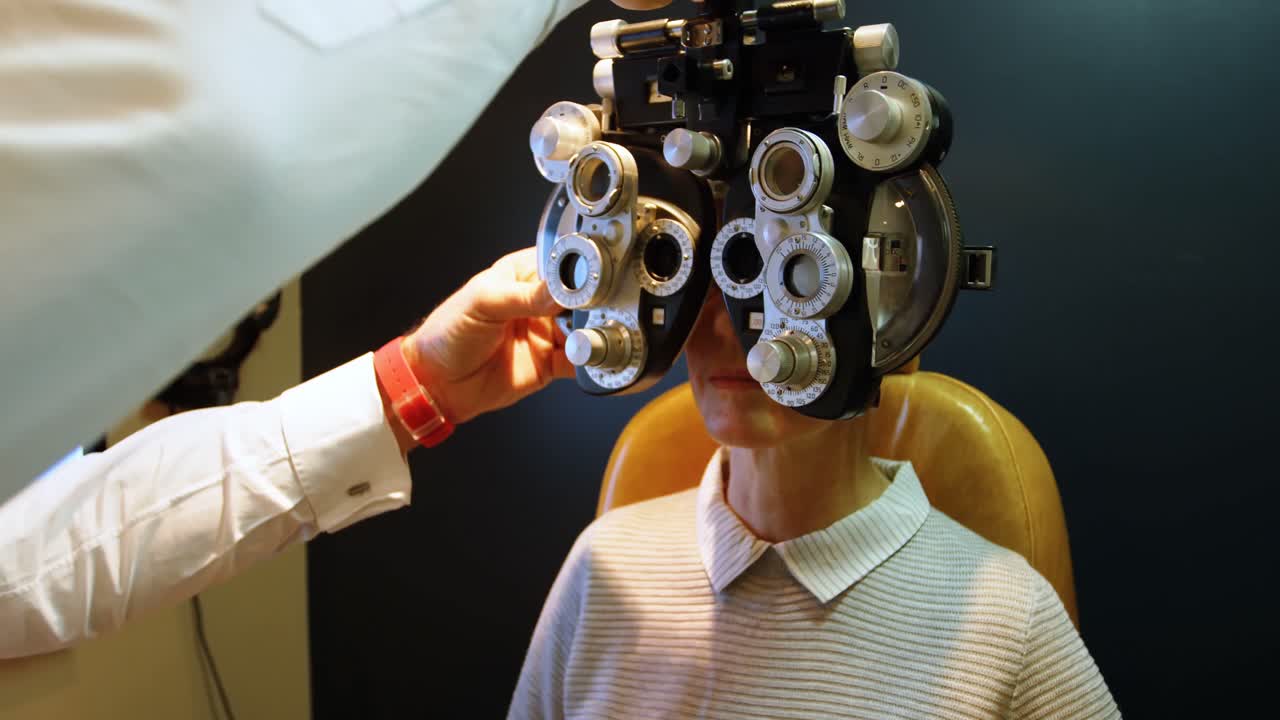 Optometrist examining patient eyes with phoropter 4k