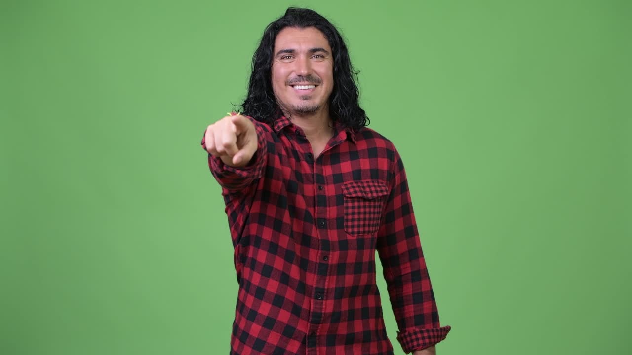 Handsome hipster man pointing to camera