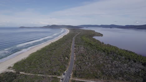 aerial view over the lakes way in forster, new south wales, australia - drone pullback