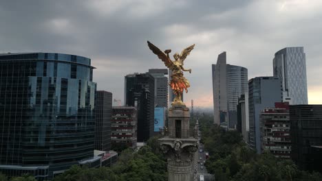 drone video capturing a close up view of the angel of independence at dusk on reforma avenue