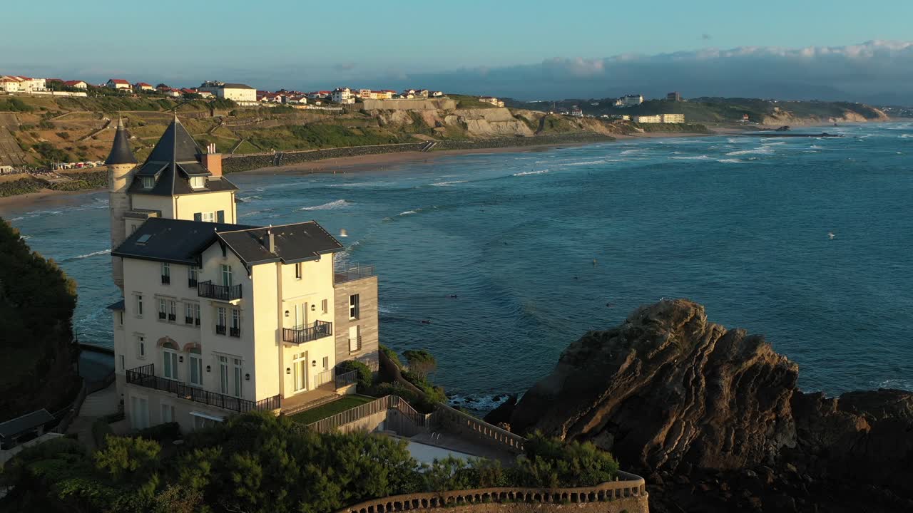 Historic Villa Belza on cliff above Atlantic, Biarritz, France, aerial forward