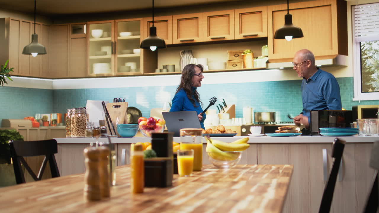 Senior married couple starting a duel with kitchen utensils for the game