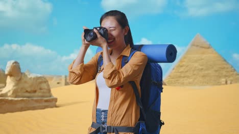 woman taking photos at pyramids in egypt