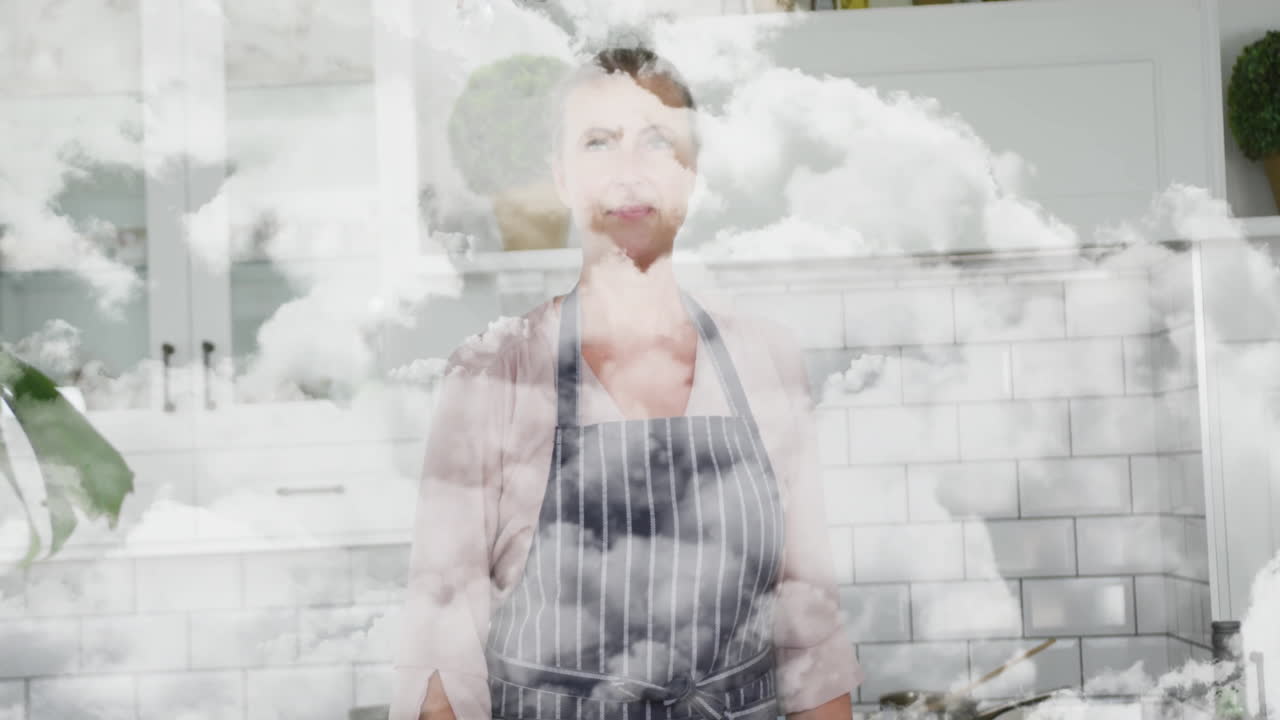 In kitchen, woman wearing apron with cloud animation effect in background