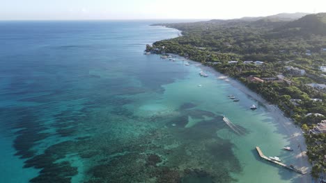 riding a boat at bay islands honduras with coral reef view