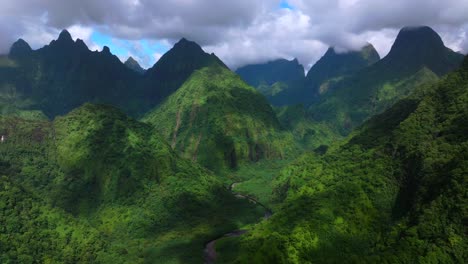 vallee de tautira river valley bay vaitepiha village tahiti island french polynesia aerial drone jagged mountain peaks canyon ravine mount aorai taiarapu taravao north shore sunny clouds down motion