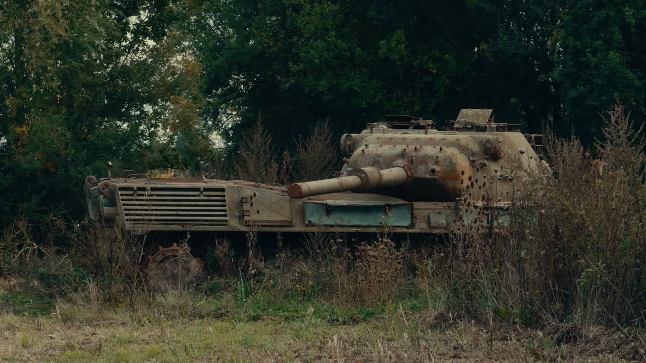 Abandoned Rusty Military Tank in Overgrown Field