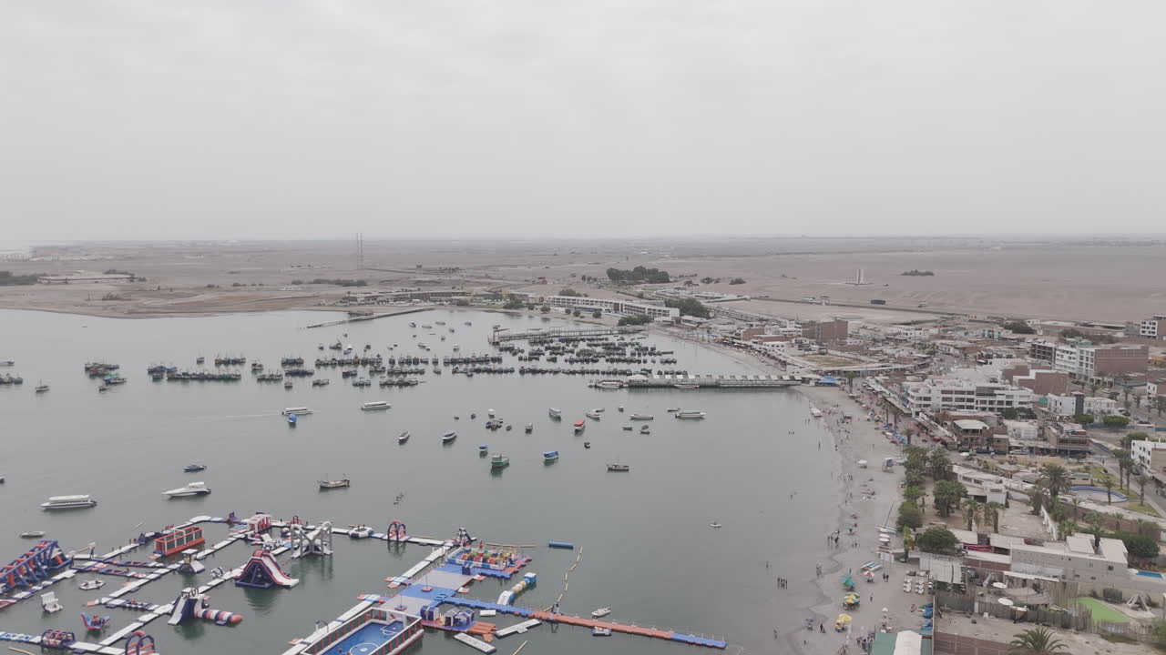 Drone shot above the city Paracas in Peru during a cloudy day LOG