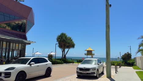 vehicles parked by beachside lifeguard tower