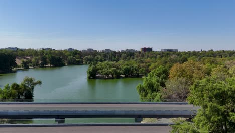 aerial shot of tineretului park, highlighting a bridge and a small lake amidst greenery, bucharest, romania