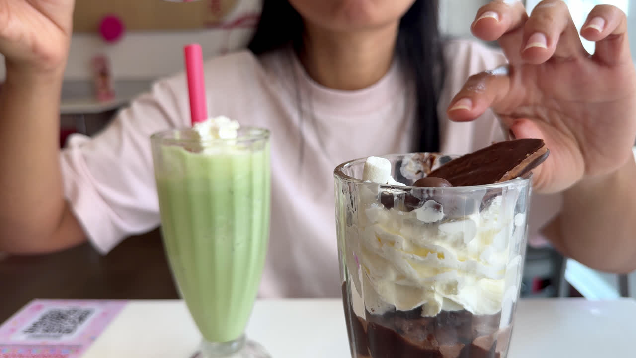 A Woman Savoring a Frappe and Ice Cream at a Seaside Café on Valentine's Day - Close Up