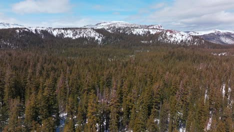 inyo national forest tioga pass road yosemite minarets summit mountains mammoth lakes ski resort vista point view california aerial drone sunny clouds daytime snow forward pan up