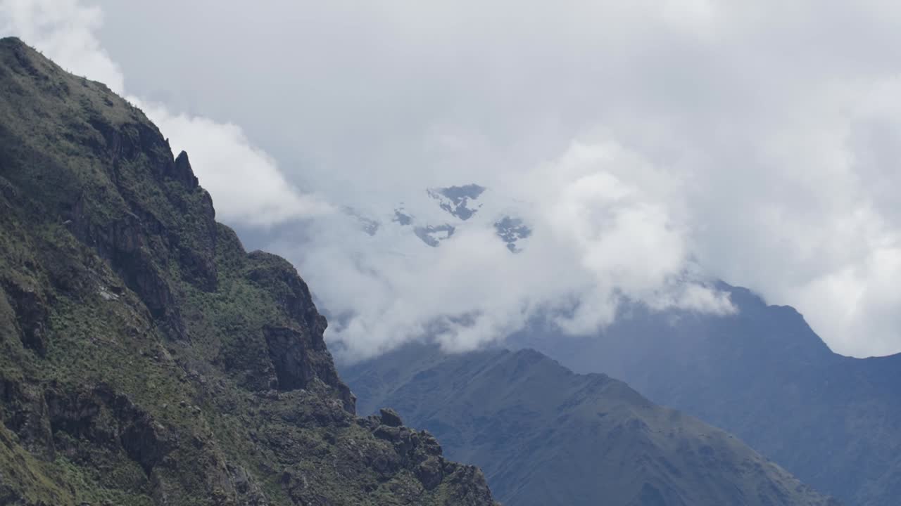 Handheld view at glacier behind clouds in Andes mountains Peru