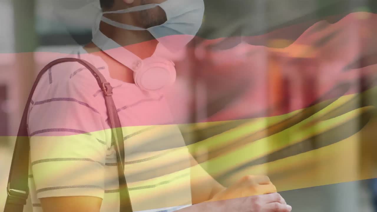 Animazione della bandiera della Germania che sventola sopra un uomo che indossa una mascherina durante la pandemia di COVID-19.