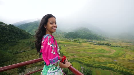 beautiful young asian girl in cultural dress in scenic rice terraces background.