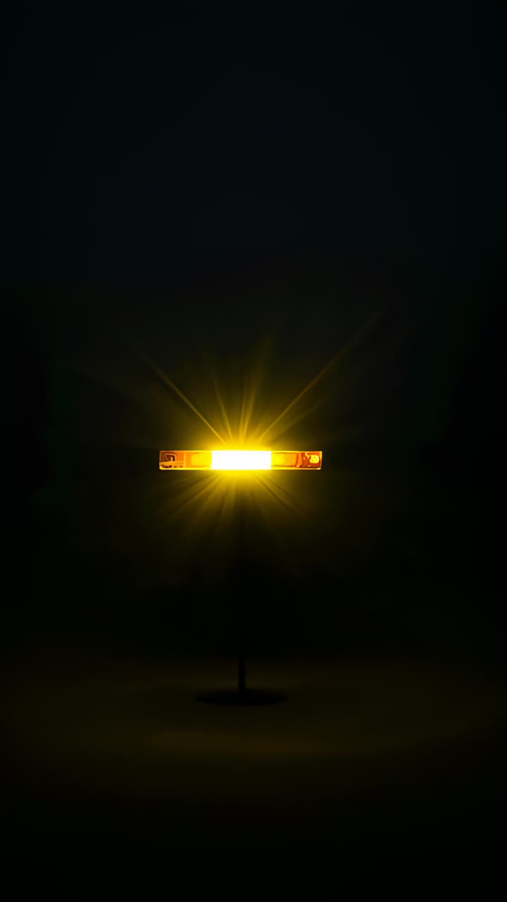 Vertical video: Switching on LED bar on stand brightening studio to light floor casting yellow halo