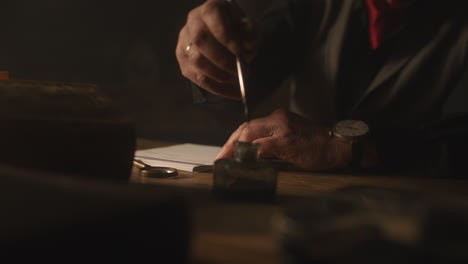 old passionate man writes a letter in his office at night