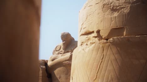 intricate carved drawings and hieroglyphs adorning the stone structures in the karnak temple, luxor egypt slow slide movement sideways.