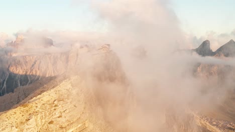 Aerial-arc-of-Nuvolau-mountain-hut-perched-atop-peak-of-Mount-Nuvolau-at-sunset