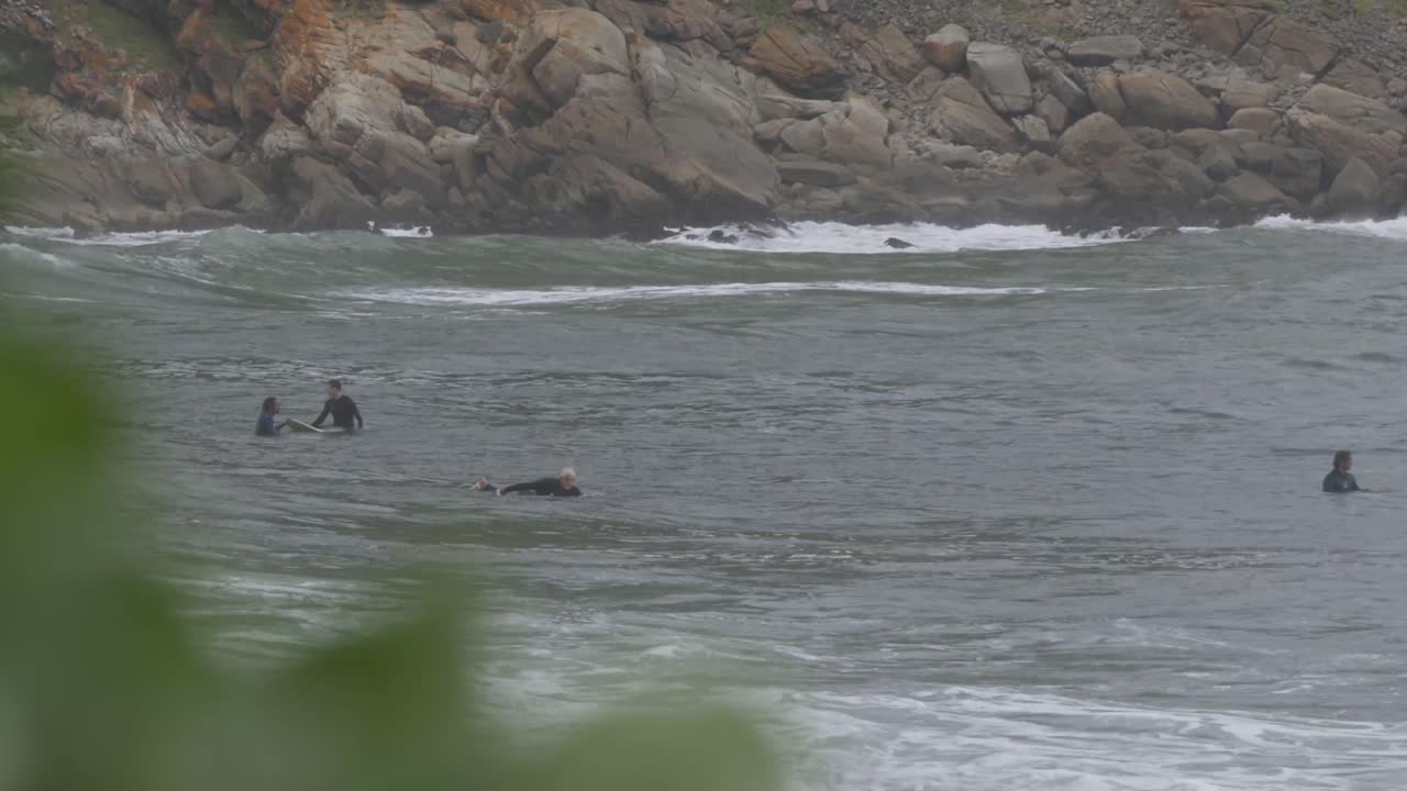 Shot of surfers try riding on high waves at Beach